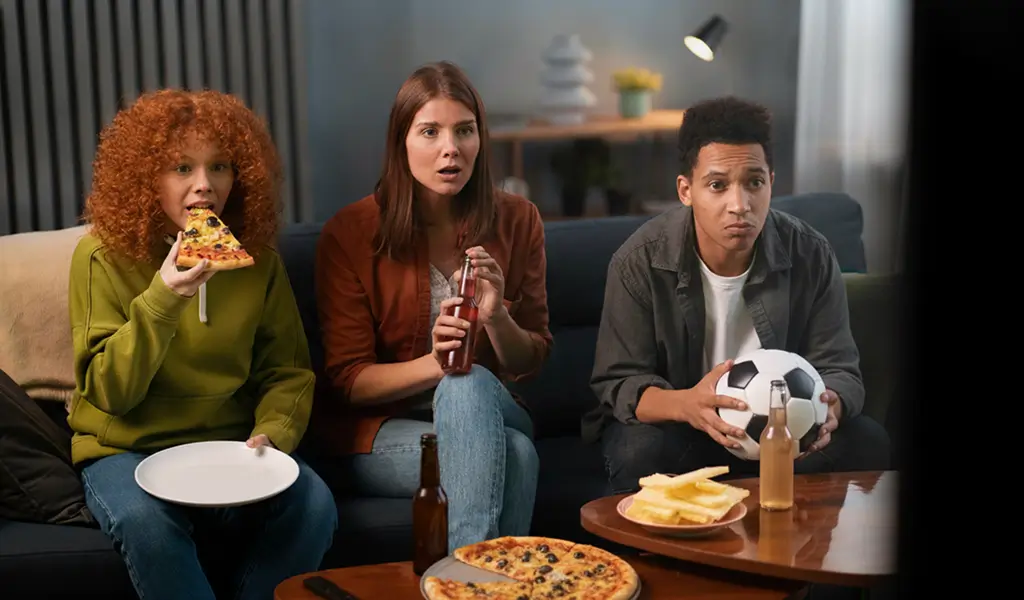 people eating eatons pizza and watching football
